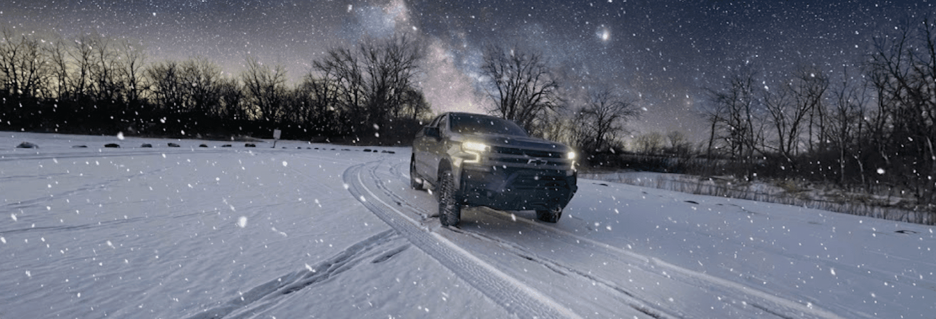 Truck under starry winter sky
